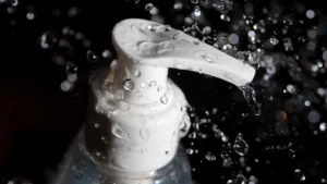 a white lotion pump in black background